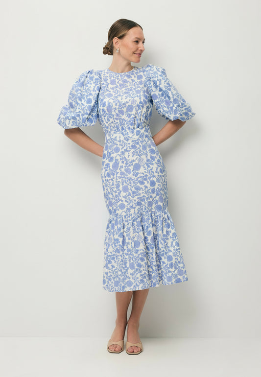 Modelka patrząca w bok ubrana w midi sukienkę w autorski print MOSELLE.