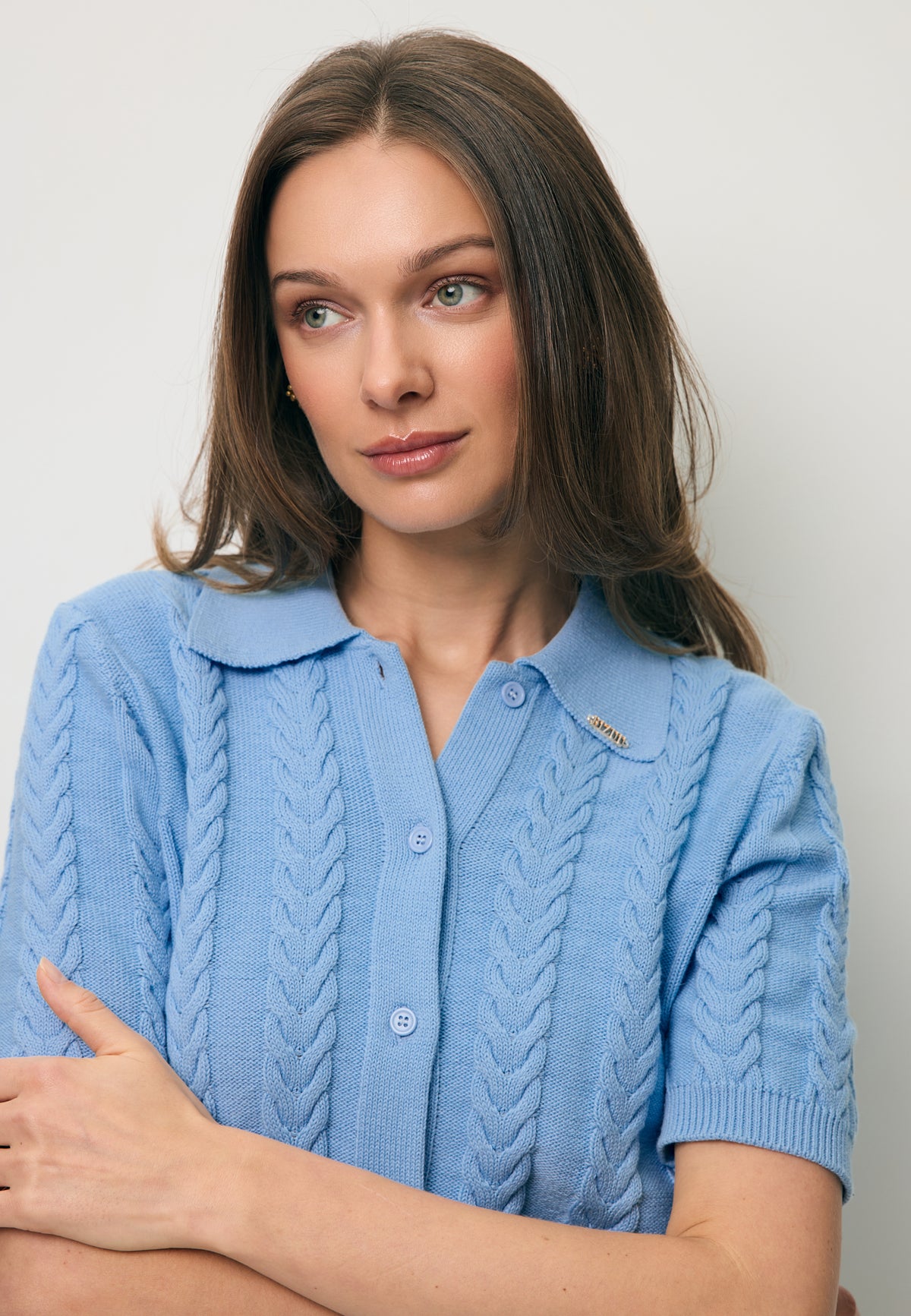 Zbliżenie na modelkę w niebieskim sweterku polo z krótkim rękawem PATRI.